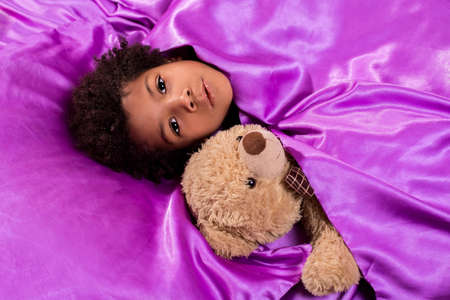 Black kid with teddybear. Child in bed with teddybear. Close your eyes. Don't worry - you're at...