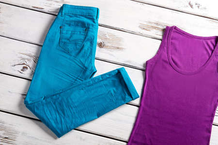 Bright female top and pants. Jeans and top on showcase. Woman's stretch jeans and top. Lady's colorful clothing for summer.の写真素材