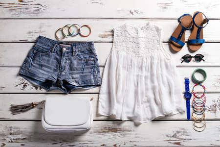 Woman's top with lace insert. Female wardrobe on wooden backround. Delicate clothes for woman. Garments from summer collection.の写真素材