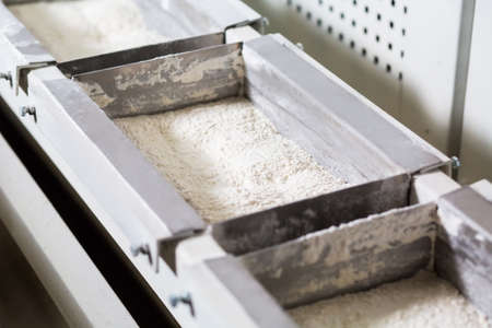 Boxes with the flour in the production hall. Sale of flour. Production of flour. Conveyor with flour.の写真素材