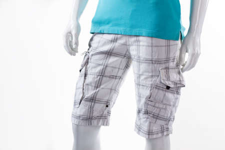 White checkered shorts on mannequin. Male mannequin in cargo shorts. Men's shorts with pockets. Light cotton summer shorts.の写真素材