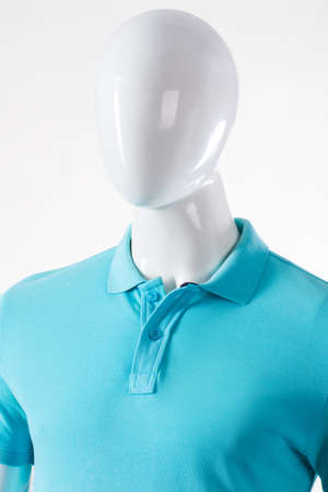 Light polo t-shirt on mannequin. Male mannequin wearing polo t-shirt. Blue garment of natural fabric. Men's fitted polo t-shirt.の写真素材