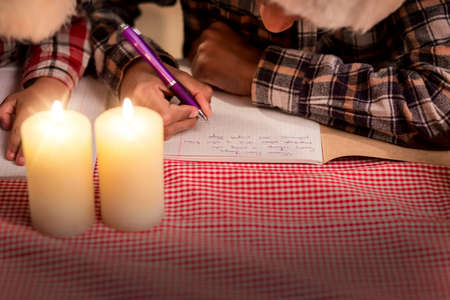 Children write letter on Christmas. Young boys writing Christmas letter. Dear Santa, come to us. Expressing holiday thoughts.の写真素材