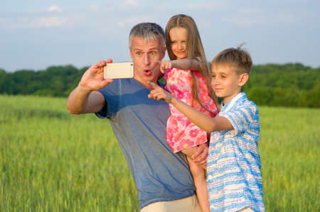 Family selfie. Family on nature. Dad with children.の写真素材