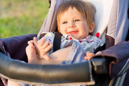Little boy in a pram.Baby smiling. Cute kid.の写真素材