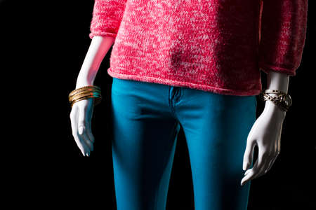 Pink pullover, watch and bracelet. Mannequin wearing pullover and accessories. Lady's warm garment for spring. Classic watch and gold bracelet.の写真素材