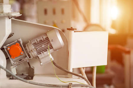 Industrial equipment and wires. Wires connected to device. Small electric motor. Fast-paced energy production.の写真素材