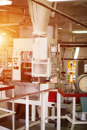 Industrial machine with control panels. Conveyor with buttons and switches. Powerful machinery at...
