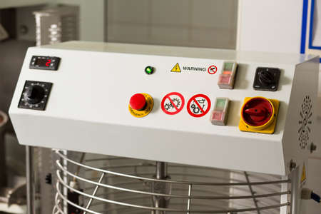 Red button and indicators. Panel with buttons and switches. Always follow the safety protocols. Part...