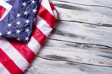 Crumpled flag of America. American flag on wooden background. Preserve the rights and freedoms. Land...
