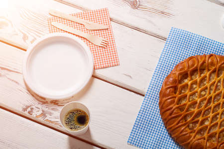 Pie with plate and cutlery. Drink and pie on napkin. Tasty breakfast at the bistro. Hot coffee and...