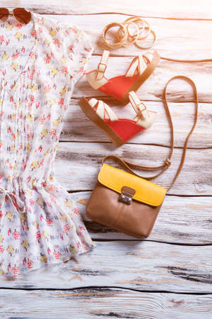 Blouse, wedge sandals and bracelets. Colorful bracelets with purse. Woman's fashionable outfit on display. New colorful design.の写真素材
