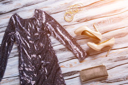 Sparkly dress and heel shoes. Evening dress, footwear and purse. Female clothing of stylish design....