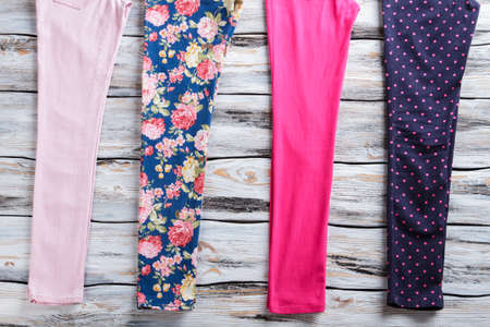 Floral and light pink pants. Stylish female trousers with print. Summer clothing on white floor....