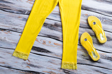 Yellow flips flops and pants.の写真素材