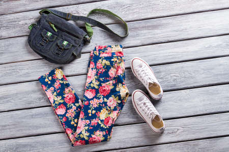 Floral pattern pants and bag with casual shoes.の写真素材