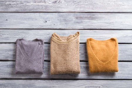 Folded sweaters of different color.の写真素材