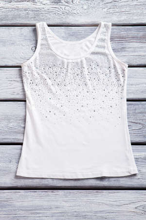 Tank top on wooden background.