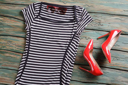 Black and white striped top. Sunglasses and red glossy heels.の写真素材