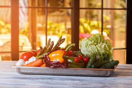 Cucumbers and tomatoes on tray.の写真素材
