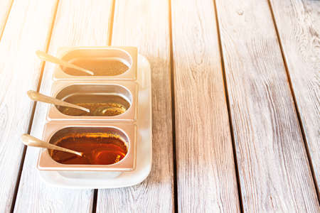 Sauce containers and spoons.の写真素材
