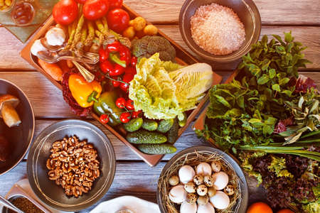 Cucumbers with tomatoes on tray. Bowl of raw rice. Ripe vegetables and herbs.の写真素材