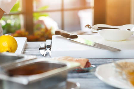 Knife on white cooking board.の写真素材
