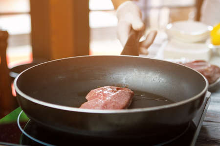 Meat on frying pan.の写真素材