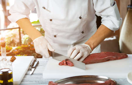 Man cutting meat with knife.の写真素材