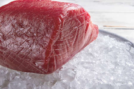 Piece of meat on ice. Red fish meat. Key ingredient for japanese dish. Best tuna for hosomaki rolls.の写真素材