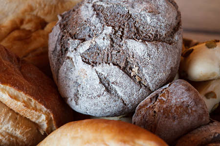 Loaf of dark brown bread. Dark bread and buns. So fresh and warm. Fruits of labor.