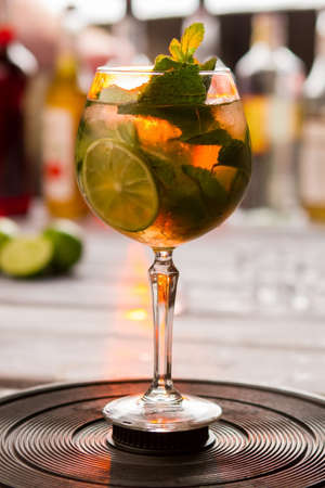 Drink with lime slice, Piece of fruit and mint.