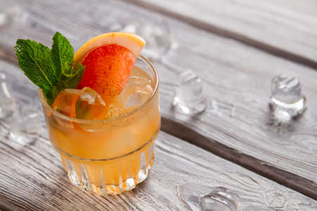 Orange drink with ice cubes with Grapefruit slice and mint.の写真素材