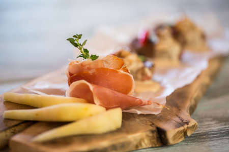 Bacon slices and green herb. Pieces of pear on board. Decoration of meat dish. Great flavour and taste.の写真素材
