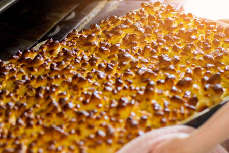 Lots of baked pastry. Oven tray with buns. Hot from the oven. Lowest prices in local bakery.の写真素材