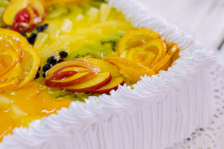 Dessert with fruits and cream. Pieces of apple in jelly. Delicious treat for party guests. Tasty cake from pastry shop.の写真素材