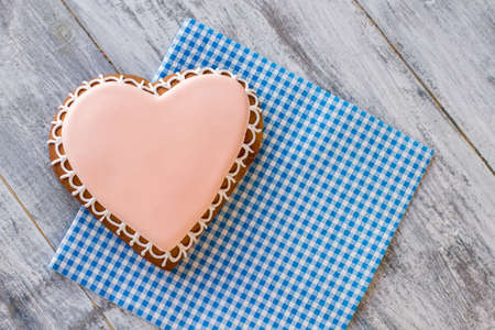 Top view of heart cookie. Glazed biscuit on checkered napkin. Love of a gourmet. Stay true to your feelings.の写真素材