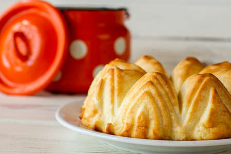 Curd casserole on white plate. Opened milk can and cheesecake. Healthy and nutritious breakfast. Cottage cheese pastry.の写真素材
