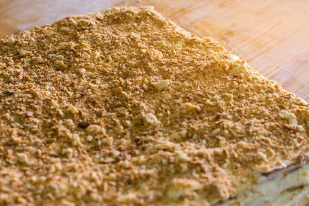 Lots of crumbled biscuits. Dessert under sunlight. Traditional napoleon cake. Puff dough and...