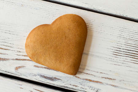 Brown heart shaped biscuit. Top view of cookie. Recipe of love and happiness. Make an ordinary day special.の写真素材