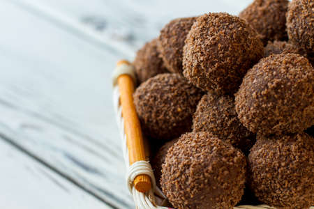 Dark sweets with crumbs. Pile of candies in basket. Recipe of chocolate rum balls. Delicious russian dessert.の写真素材