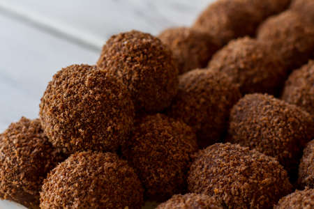 Dark ball shaped sweets. Lots of brown candies. Traditional russian dessert. Butter and crumbled...