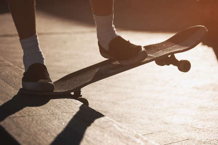 Feet on skateboard. Skateboarder is grinding. Keep the balance. Hobby of today's youth.の写真素材
