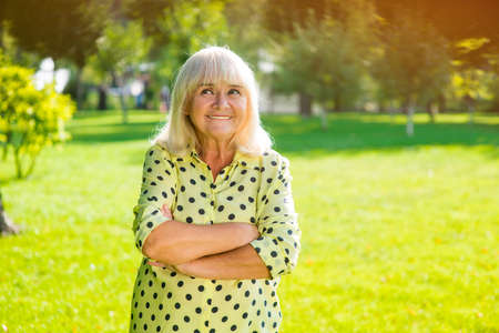 Woman with gray hair smiling. Thoughftul look of senior lady. I have a cunning plan. Reason and logic.の写真素材