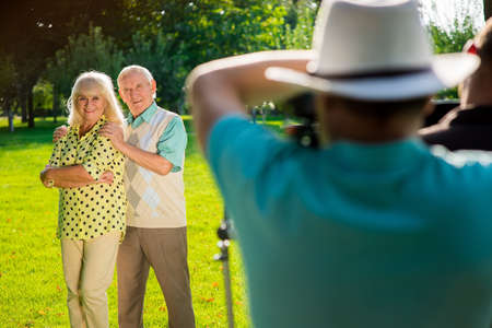 Couple of seniors standing outdoor. Elderly man and woman posing. Few pictures for family album. Confidence in each other.の写真素材