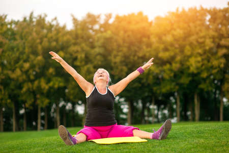 Woman with outstretched arms sitting. Lady is looking up. Perfect health and free mind. Everything...
