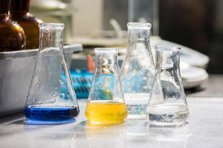 Liquids in flasks. Fluids of different color. Chemicals for an experiment. Development of new antibiotic.の写真素材