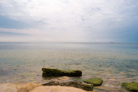 Sea with sky. Stones and water. Away from civilization. Good vacation spot.の写真素材