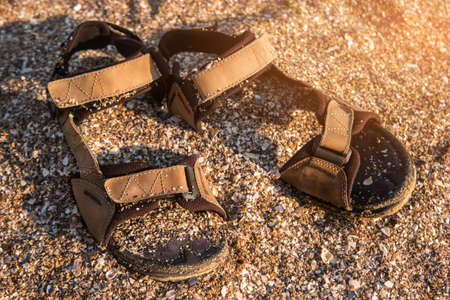 Sandals covered in sand. Crushed seashells and sand. Get lost on the island. Escape to the sea.の写真素材