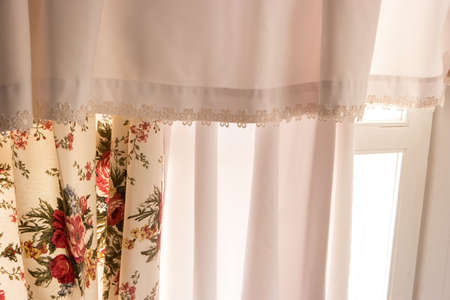 White curtains and window. Cloth with floral pattern. Simplicity of design. Welcome the new day.の写真素材